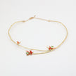 Handmade brass branch choker with red floral enamel and green crystals, handcrafted in Greece.