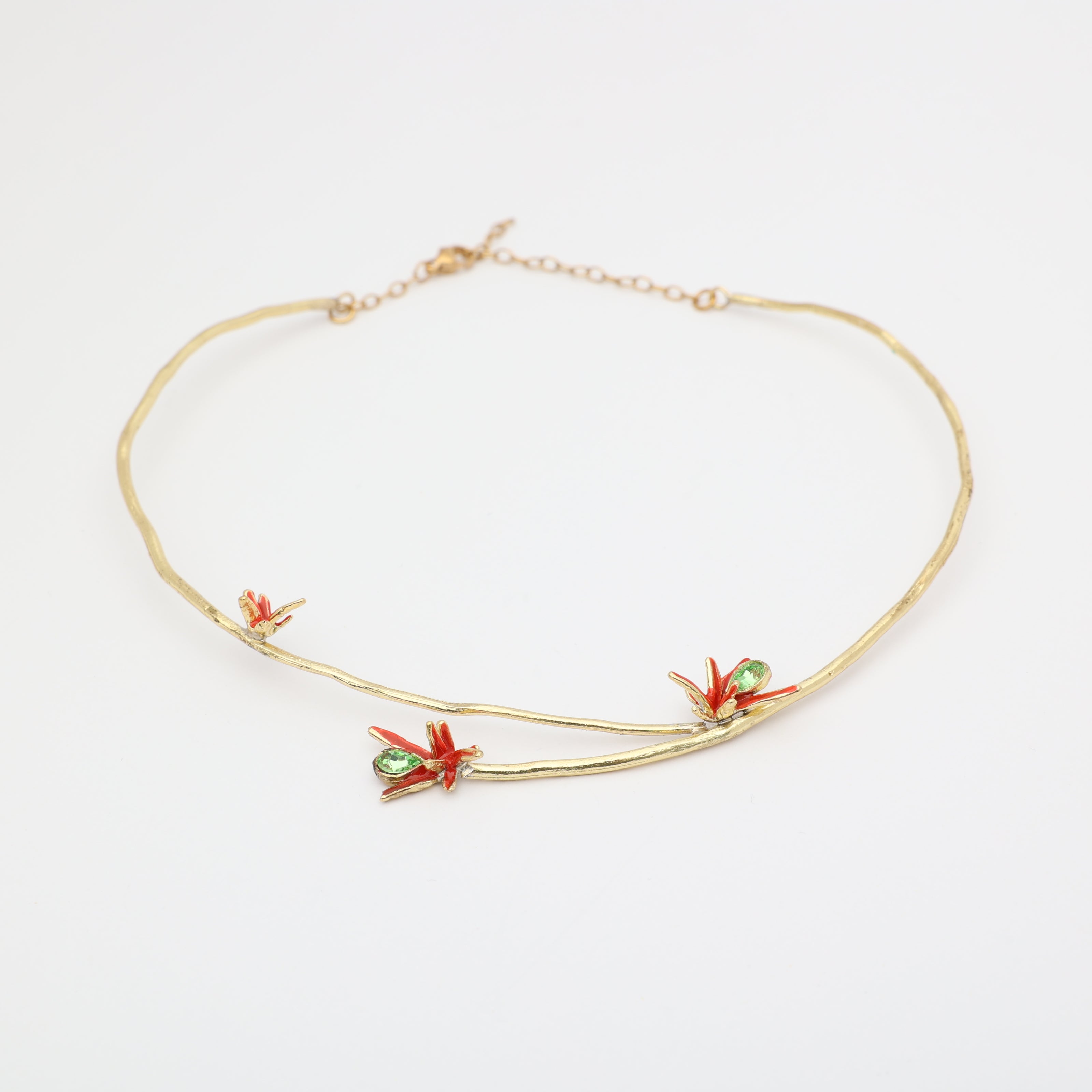 Handmade brass branch choker with red floral enamel and green crystals, handcrafted in Greece.