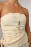 Dragonfish Necklace — handmade brass sculptural long necklace with raw pendant and patina finish on model, artisan jewelry made in Greece