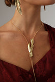 Dragonfish Necklace — handmade brass sculptural lariat necklace with raw pendant on model, styled with matching earrings