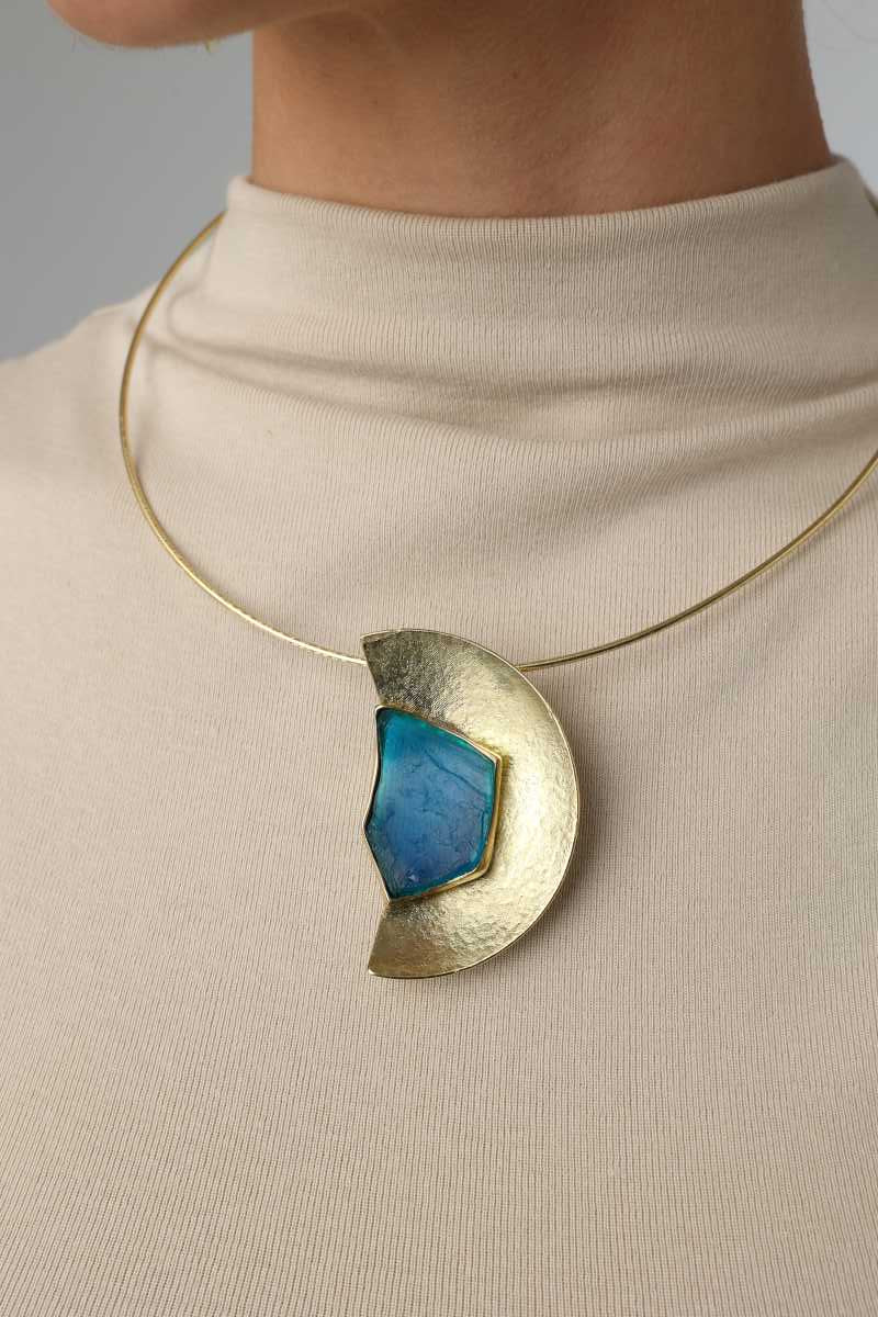 Pond Necklace — handmade brass large semicircle pendant necklace with raw stone on model, full chest view