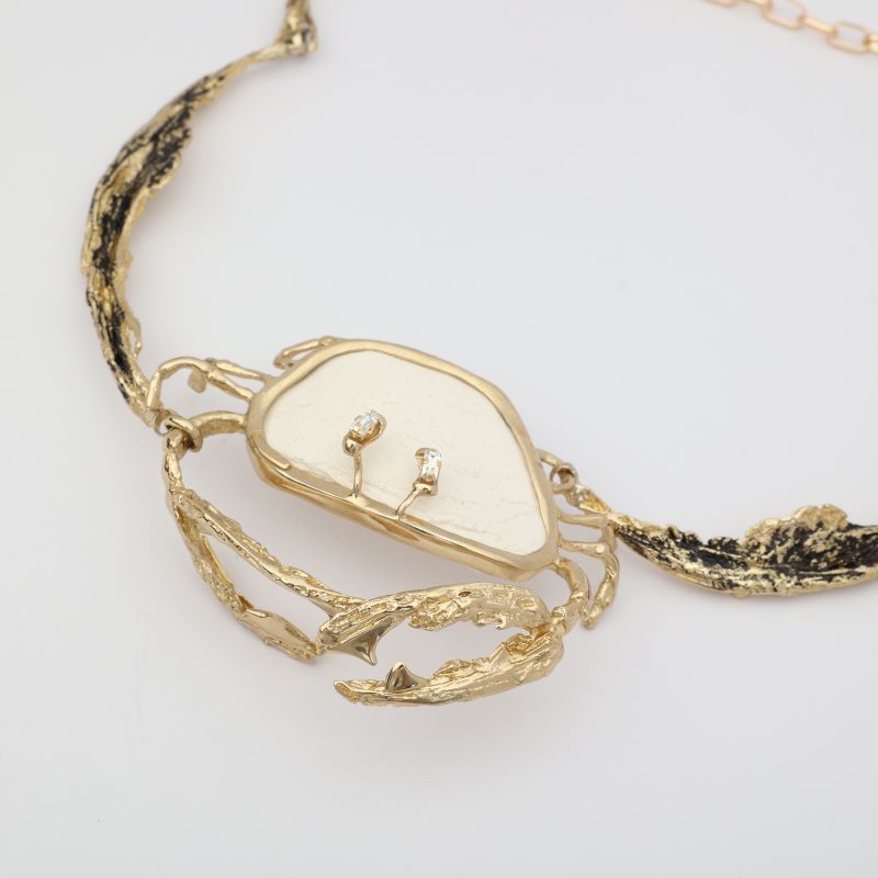Crasta Necklace close-up — handmade brass sculptural crab statement necklace with natural stone, artisan jewelry made in Greece