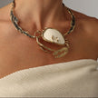 Crasta Necklace — handmade brass sculptural statement necklace with natural stone crab pendant on model, styled with matching earrings