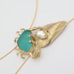 Claw Crabby Necklace side view — handmade brass sculptural necklace with crab, shell and pearl detail on fine chain