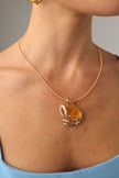 Crabby Necklace on model — handmade brass sculptural crab pendant necklace worn showing scale on wire collar