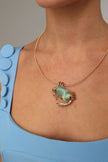 Crabby Necklace detail — handmade brass crab necklace with textured claws and legs framing large organic resin stone
