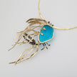 Kora Necklace detail — handmade brass necklace with crystal baguettes set into freeform resin stone on hammered collar
