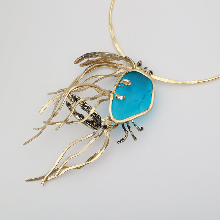 Kora Necklace detail — handmade brass necklace with crystal baguettes set into freeform resin stone on hammered collar
