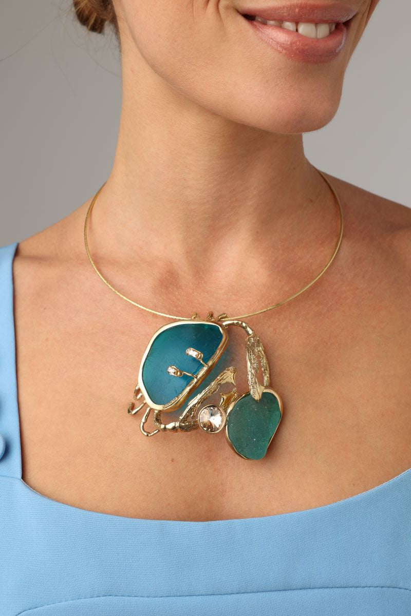 Crabby The Thief Necklace — handmade brass statement necklace with sculptural crab pendant on model