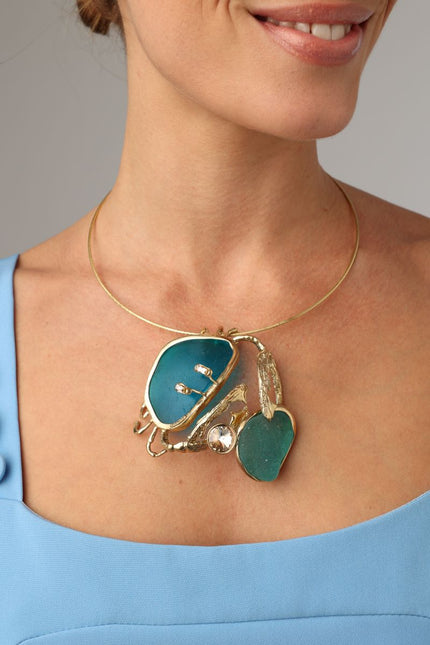Crabby The Thief Necklace — handmade brass statement necklace with sculptural crab pendant on model
