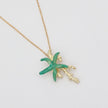 Astel Necklace — handmade brass starfish pendant necklace with enamel and coral branch detail, flat lay