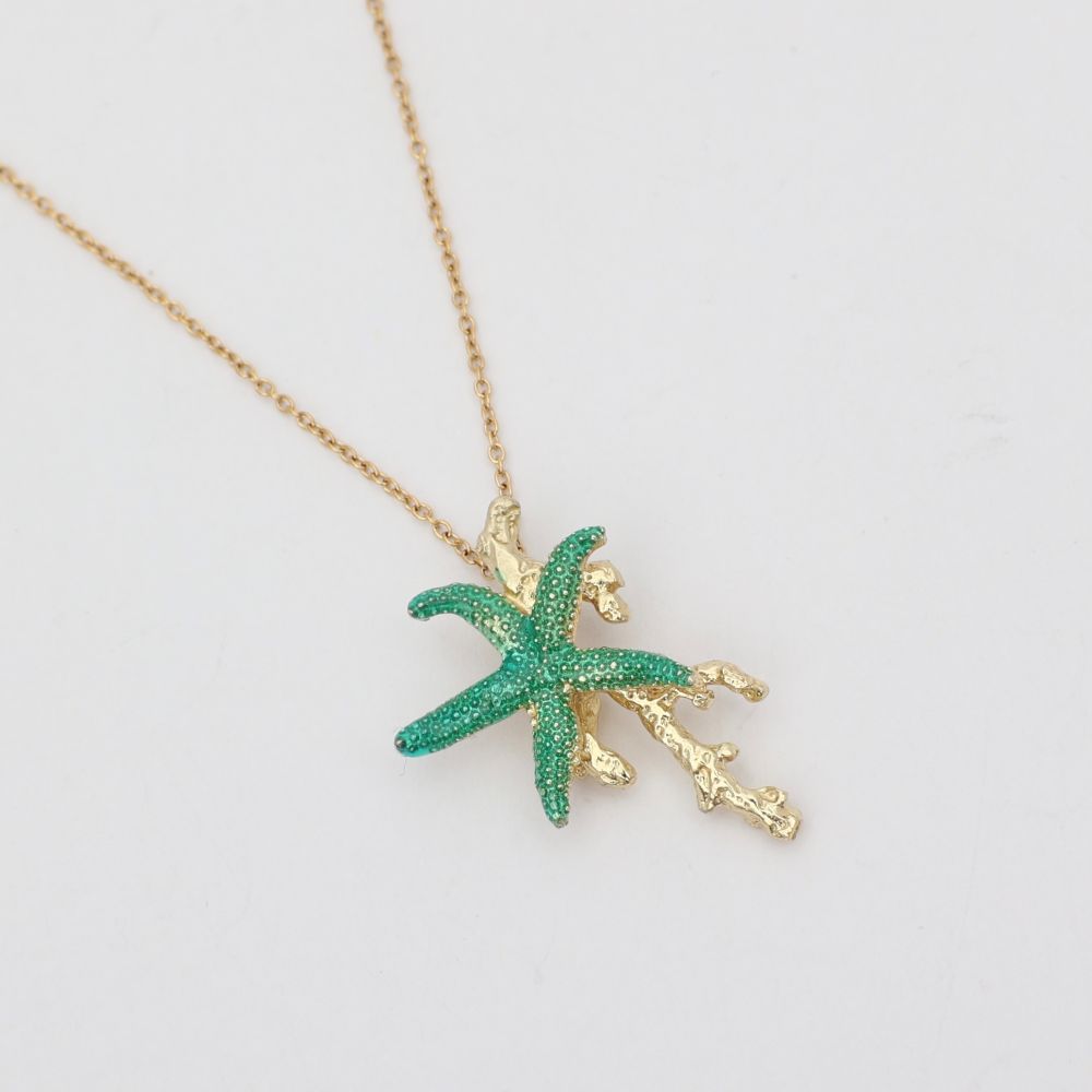 Astel Necklace — handmade brass starfish pendant necklace with enamel and coral branch detail, flat lay