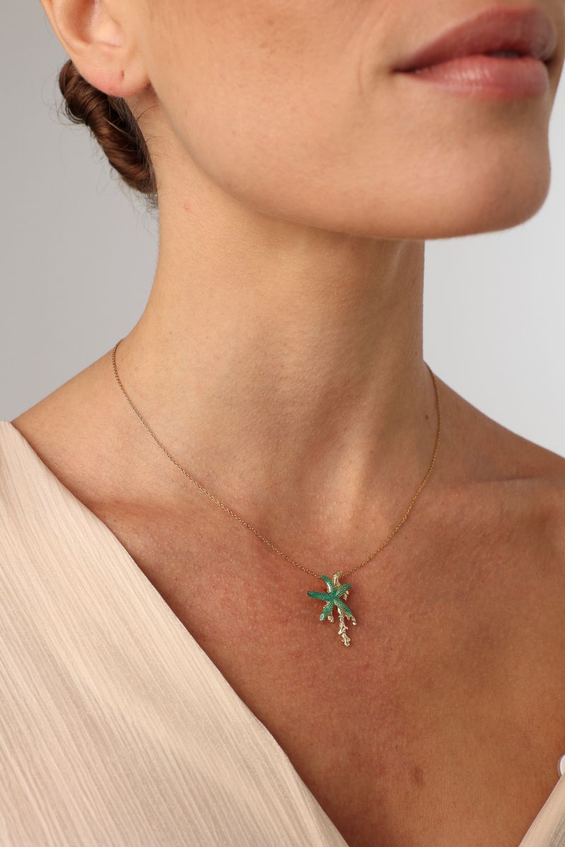 Astel Necklace — handmade brass enamel starfish pendant necklace on model, close-up