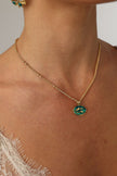Delphi Necklace — handmade brass enamel pendant necklace with swallow motif on satellite chain, worn on model