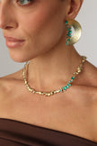 Gold-tone handmade brass necklace with organic molten texture and green enamel accents, crafted in Greece.