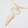 andmade brass torque and sculptural goddess pendant necklace, flat lay front view