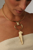 handmade brass torque necklace with Greek goddess pendant on model, décolleté view