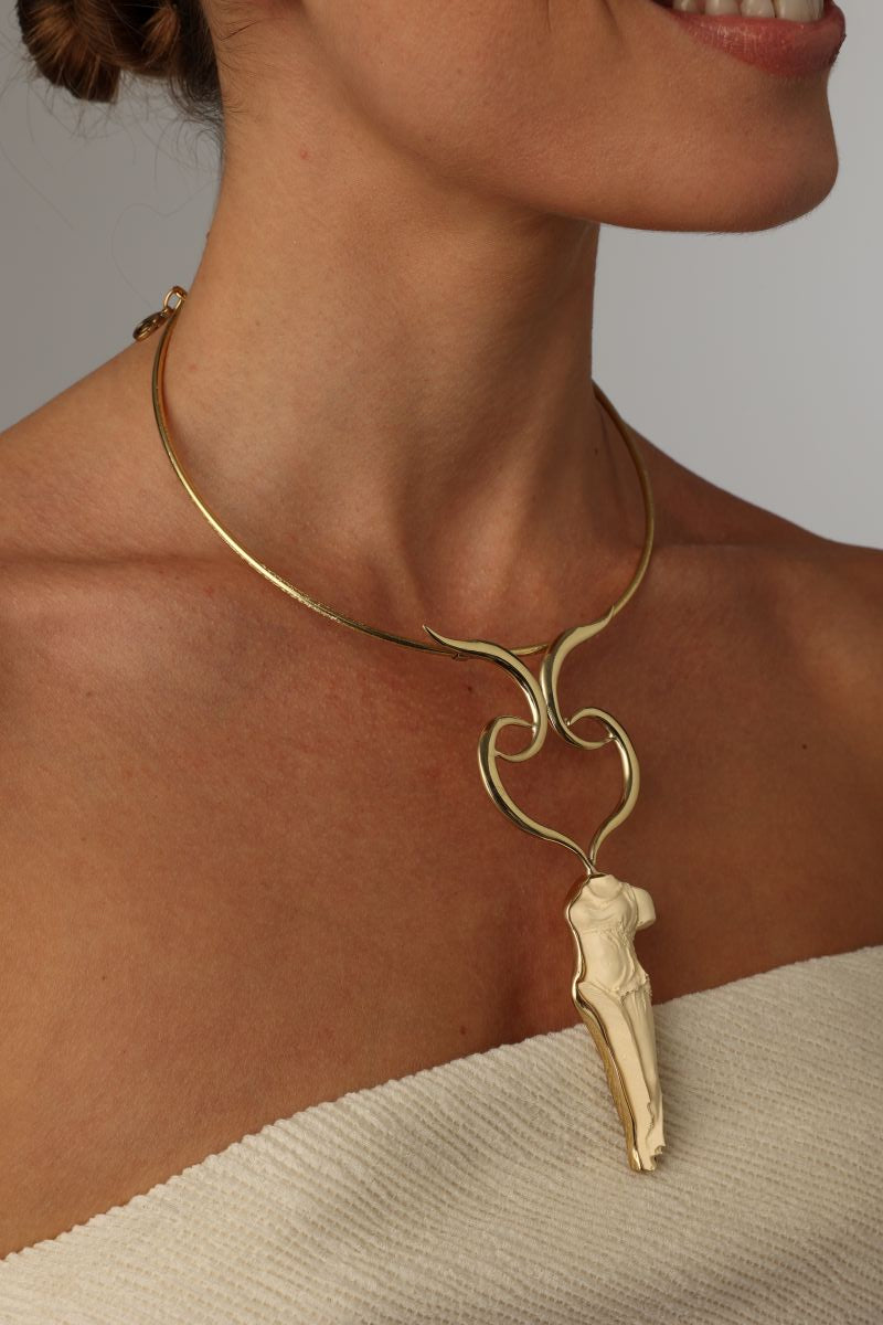 handmade brass torque necklace with Greek goddess pendant, close-up on model side view