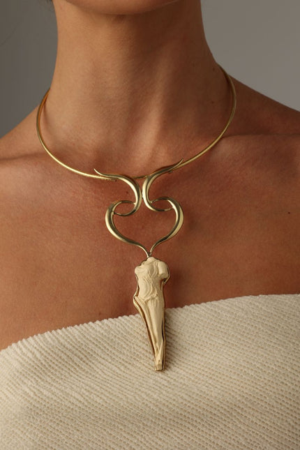  handmade brass sculptural torque statement necklace with goddess pendant on model, front view
