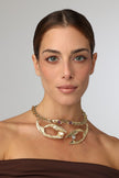 King Astor Necklace — handmade brass statement choker necklace with wave forms and gemstones on model, front view