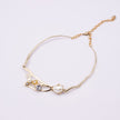 Brass branch-shaped choker necklace with pearl and crystal detail, product shot, Nerea