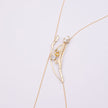 Brass wire necklace with branch-shaped pearl and crystal pendant, product shot, Nerea Long