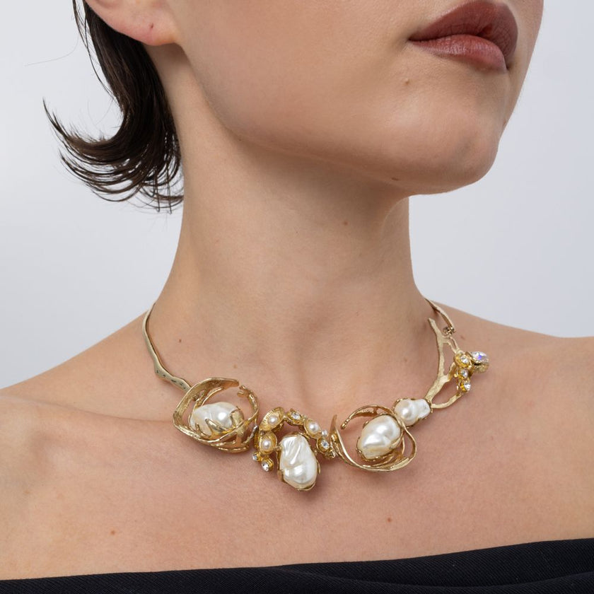 Handmade brass statement necklace with clustered pearls worn on neck, close-up