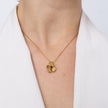 Handmade brass flower pendant necklace with amethyst crystal center, worn, Posy