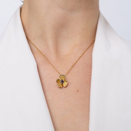 Handmade brass flower pendant necklace with amethyst crystal center, worn, Posy