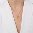 Brass flower pendant necklace with blue topaz crystal center