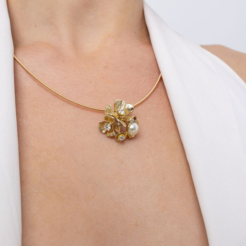 Handmade brass floral pendant with pearl worn on wire choker
