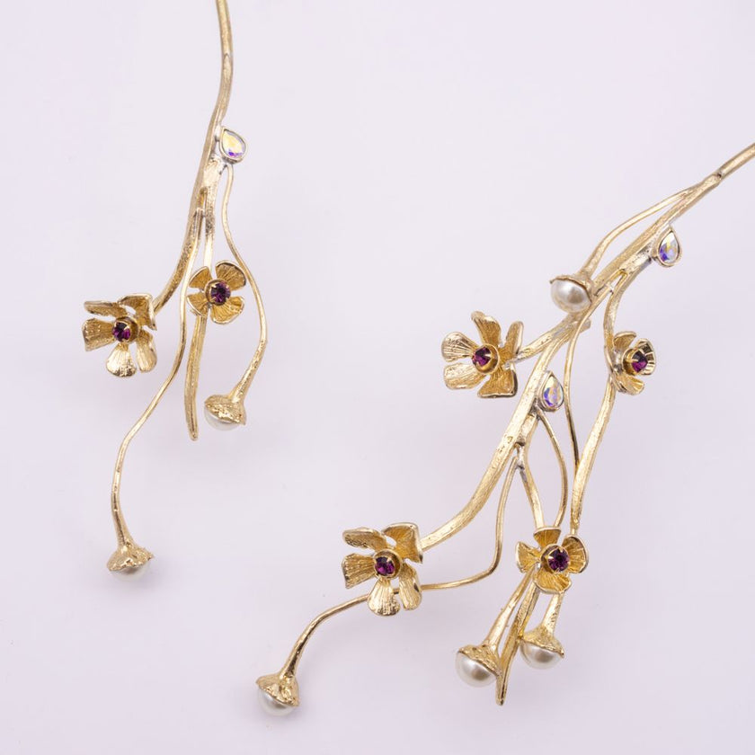Brass necklace with amethyst flower and pearl-tipped stems, detail shot