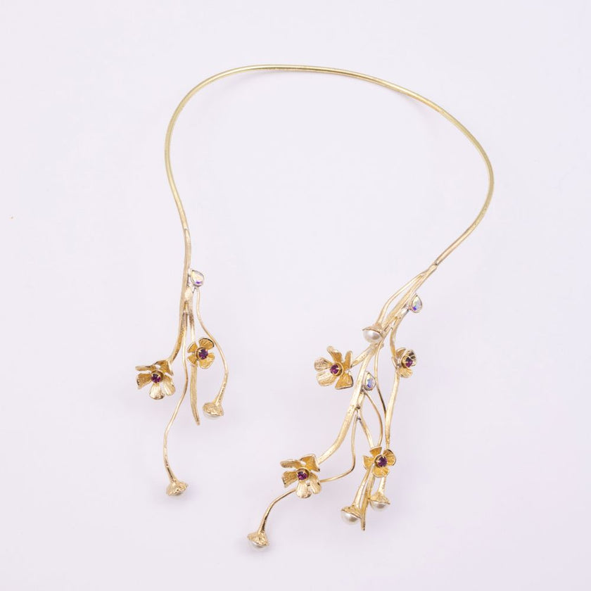 Brass open collar necklace with asymmetric floral design, product shot