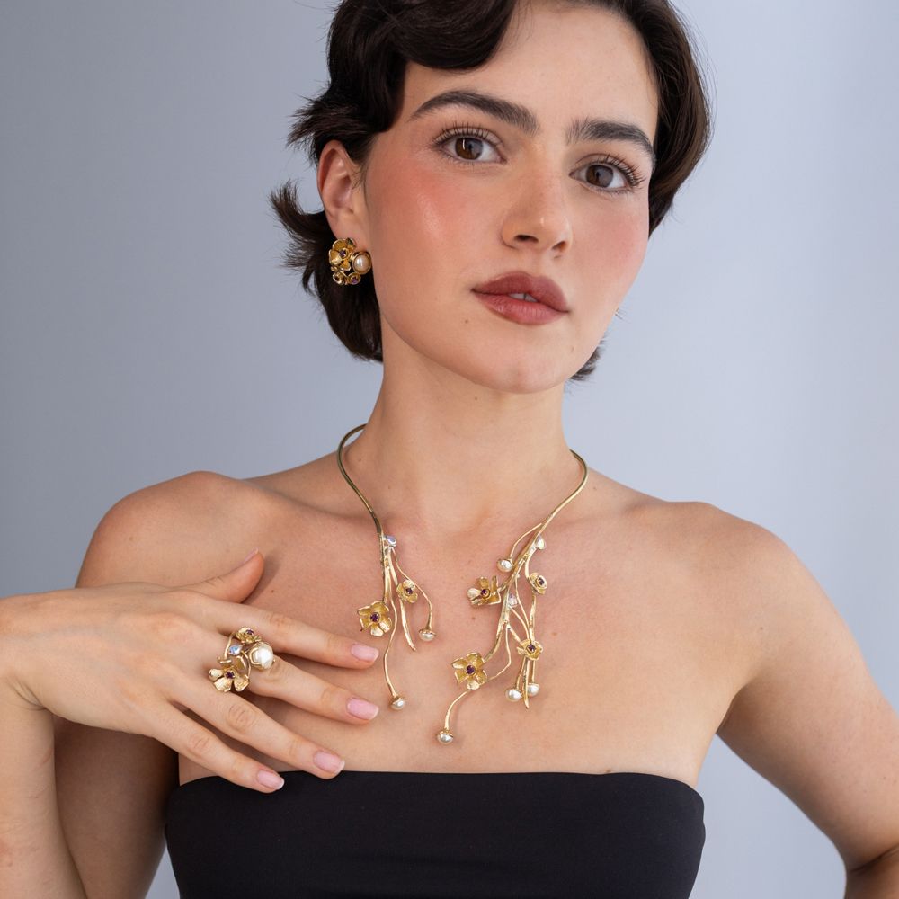 Brass floral collar necklace worn with matching ring and earrings