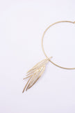 Pine handmade gold-plated brass choker necklace with layered pine-needle pendant on a white background