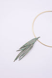 Pine handmade gold-plated brass choker necklace with green patina pendant on a white background