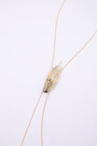 Peacock handmade gold-plated brass long necklace with black oxidized peacock and clear crystal feather tips on a white background