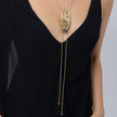 Woman wearing the gold Peacock long lariat necklace with black oxidized bird, clear crystals and ball-tipped cords, Savage Flora