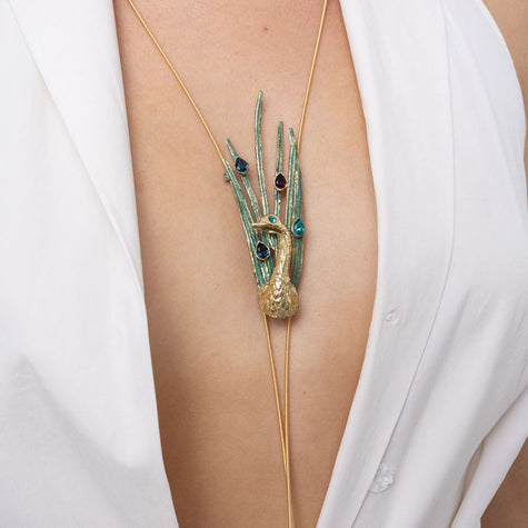 Close-up of the Peacock long necklace with gold peacock, green patina plumes and colorful crystals on fine gold cords, Savage Flora