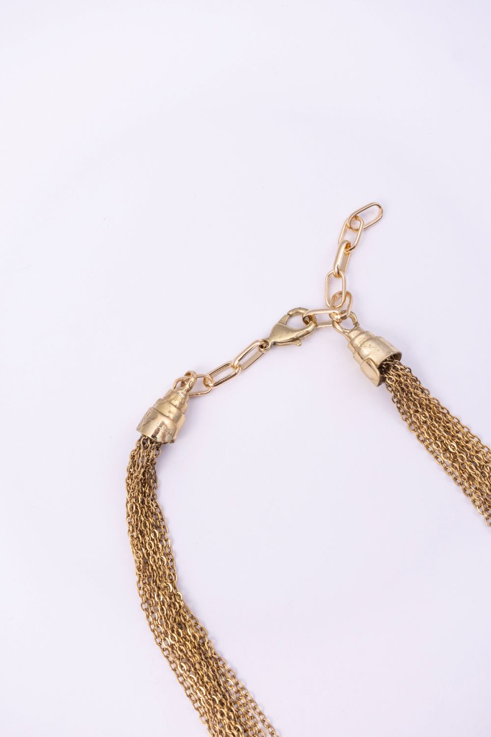 Double Peacock necklace clasp and adjustable gold chain detail on a white background