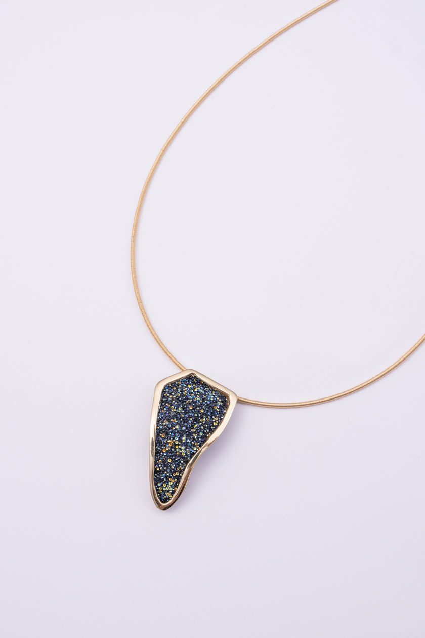 Edge Necklace on white background: handmade brass statement necklace with crystal pendant and slim coiled cord