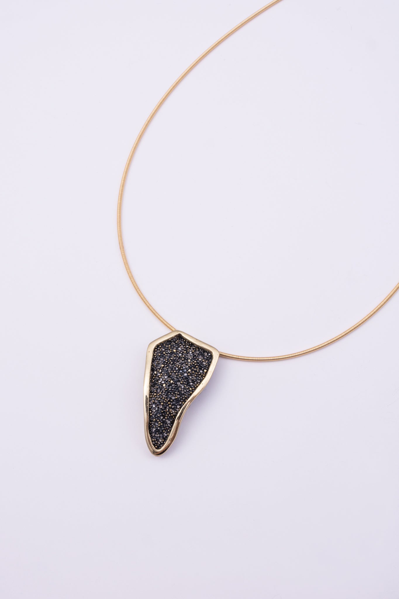 Edge Necklace front view: handmade brass geometric pendant necklace with faceted crystal surface