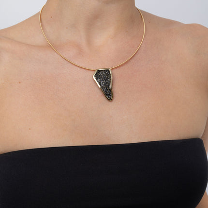 Edge Necklace on model, close up: handmade brass statement necklace with angular crystal pendant