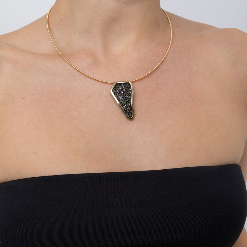 Edge Necklace on model, close up: handmade brass statement necklace with angular crystal pendant
