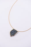 Sparkle Necklace front view: handmade brass geometric pendant necklace with faceted crystal surface