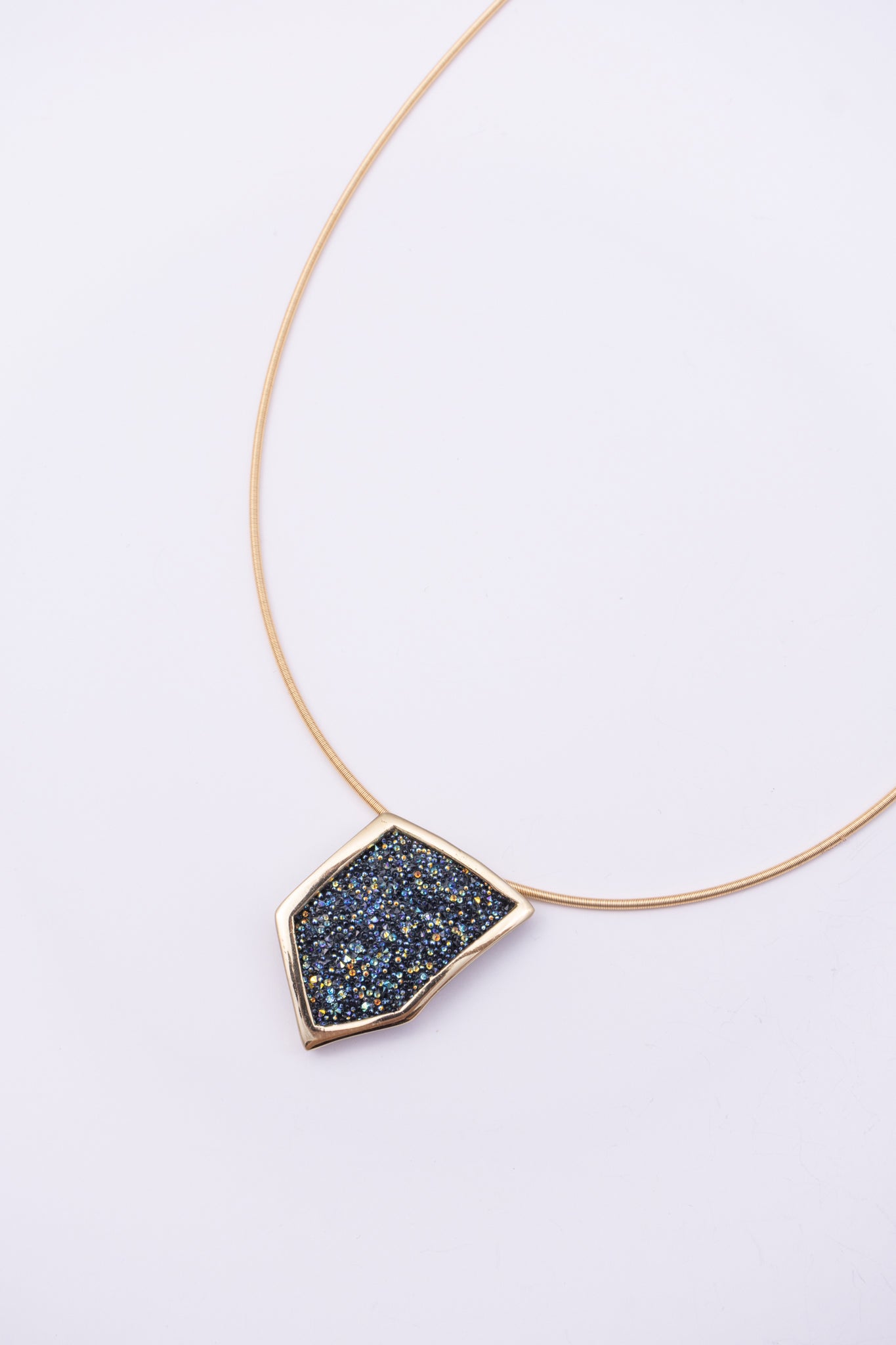 Sparkle Necklace front view: handmade brass geometric pendant necklace with faceted crystal surface