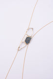 Glow Long Necklace on white background: handmade brass long necklace with crystal shard and open loops on slim coiled cord