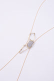 Glow Long Necklace close up: handmade brass pendant with tiny faceted crystals framed by open organic loops