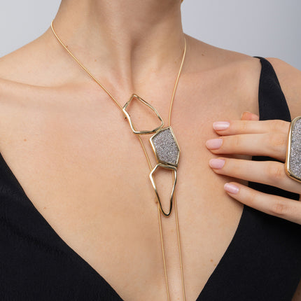 Glow Long Necklace on model: handmade brass sculptural long pendant necklace with sparkling crystals
