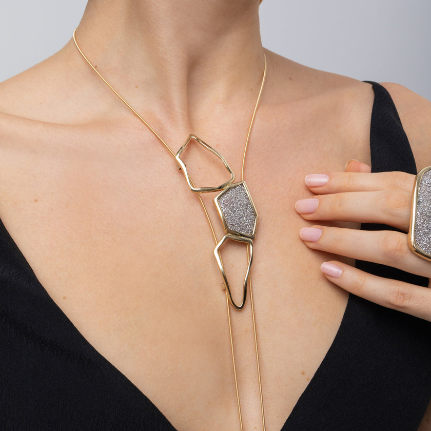 Glow Long Necklace on model: handmade brass sculptural long pendant necklace with sparkling crystals